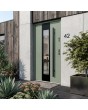 Green stainless steel contemporary door with black frame around glass