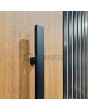 PIVOT RAIL6 - aluminum pivot door with black vertical slats made of aluminum profiles